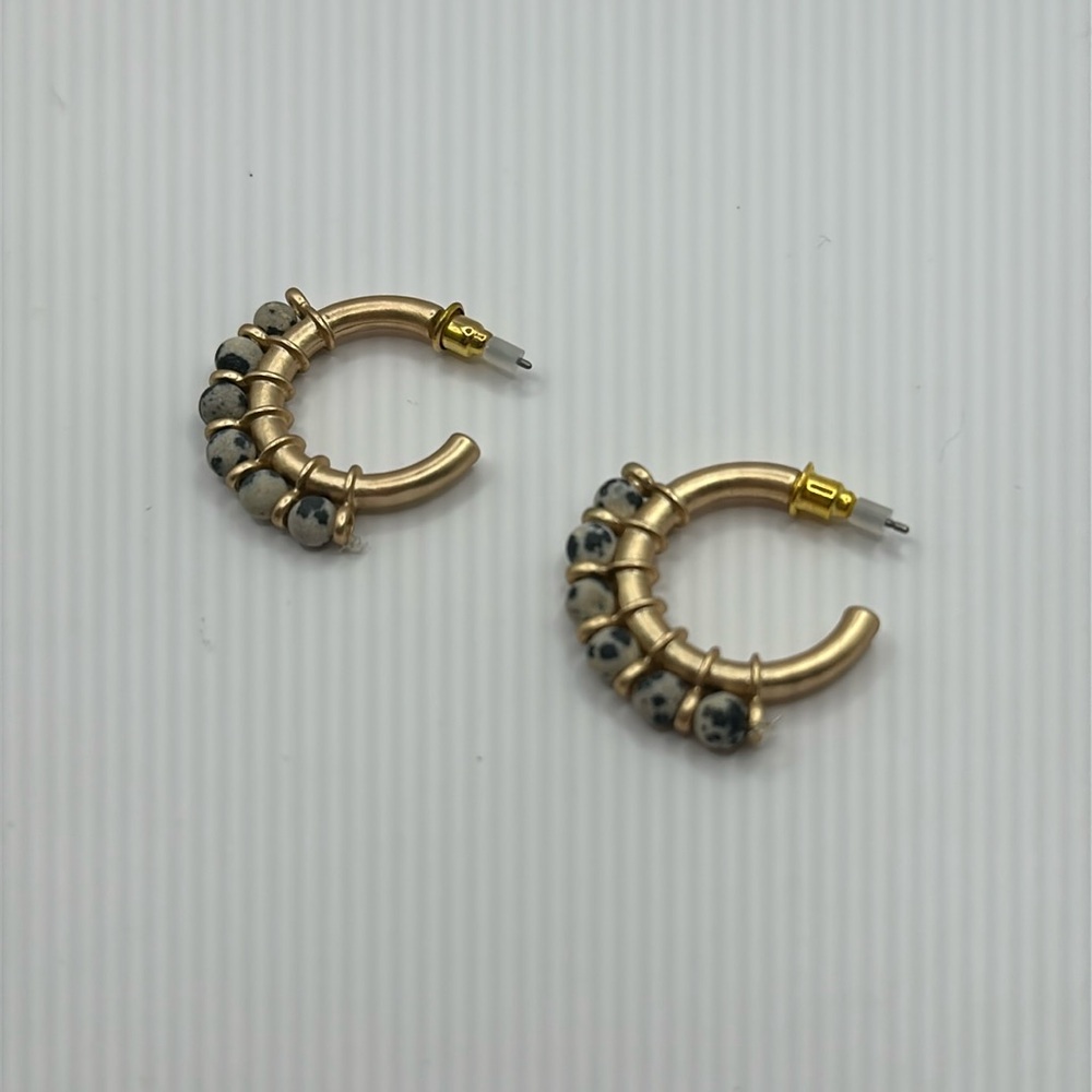 Gold-colored earrings with black and white beads